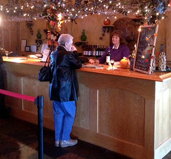 A small tasting bar greets visitors as they step into the large lodge-like winery.