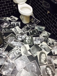 The whimsical floor of the men's room - covered in photos from French films.